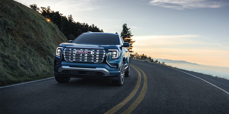 2026 GMC Terrain driving on winding mountain road, front view