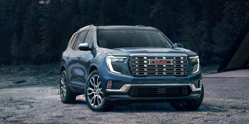 Blue GMC SUV parked in an outdoor setting.