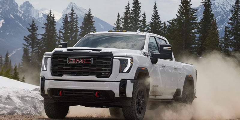 GMC Sierra 2500HD driving through snowy mountain terrain